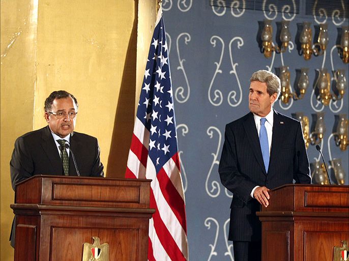 epa03934380 US Secretary of State John Kerry (R) listens to Egyptian Foreign Minister Nabil Fahmy (L) during their joint press conference, in Cairo, Egypt, 03 November 2013. Kerry Said his country will continue to support Egypt despite a decision to withhold military aid. Kerry arrived in Egypt on 03 November for the first high-level talks since the army overthrew Islamist president Mohamed Morsi in July. EPA/KHALED ELFIQI