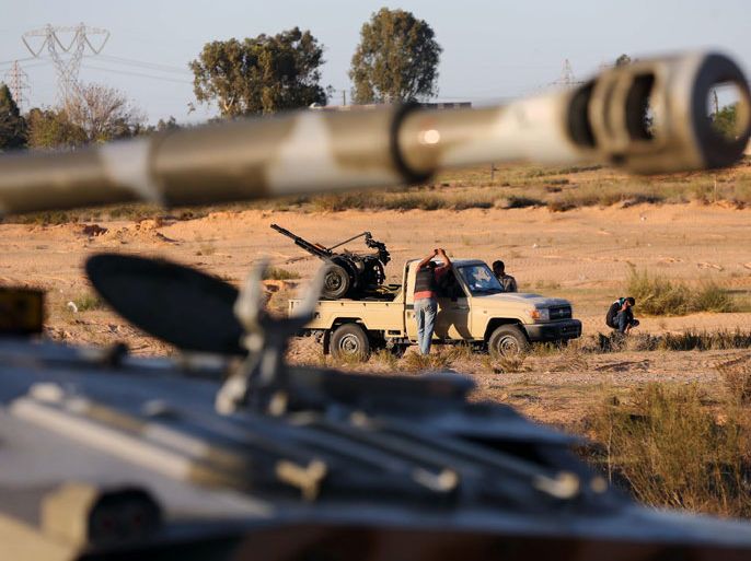 Members of the Tripoli Rebels Brigade militia patrol a main road in Tajura, 15 kms from the capital Tripoli, on November 16, 2013, after foiling attempts by Misrata-based militiamen to advance into the city earlier in the day