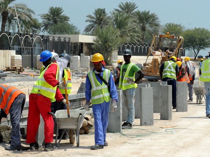 epa03895988 Foreign laborers work at the construction site for a new corniche road in Doha, Qatar, 04 October 2013. Recent media reports said immigrant workers on projects for the World Cup 2022 have been subject to abuse and harsh working conditions. An investigation by Britain's Guardian newspaper said 44 Nepalis had died in Qatar from 04 June to 08 August. EPA/STR
