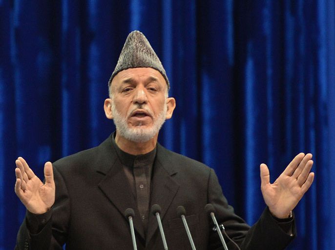 Afghan president Hamid Karzai speaks during the first day of a four-day long loya jirga, a meeting of around 2,500 Afghan tribal elders and leaders, in Kabul on November 21, 2013. Karzai backed a proposed security pact with the United States that will see up to 15,000 foreign troops remain in Afghanistan as a chance to bring stability to the wartorn country. A grand assembly of tribal chieftains, community elders and politicians began four days of debating the bilateral security agreement (BSA), which will shape Washington's future military presence in Afghanistan. AFP PHOTO/Massoud HOSSAINI