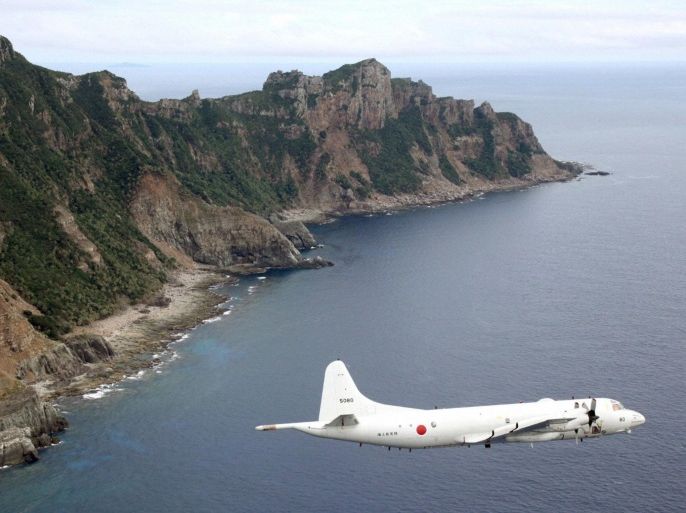 Japan Maritime Self-Defense Force's PC3 surveillance plane flies around the disputed islands in the East China Sea, known as the Senkaku isles in Japan and Diaoyu in China, in this October 13, 2011 file photo. REUTERS/Kyodo/Files