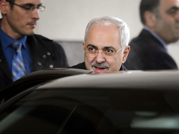 Iranian Foreign Minister Mohammad Javad Zarif (C) leaves the Intercontinental Hotel on November 20, 2013 before the start of closed-door nuclear talks in Geneva. World powers and Iran hold a fresh round of talks on the Islamic republic's nuclear programme, a month after launching ice-breaking negotiations that may yield a historic deal on easing sanctions against Tehran in exchange for concessions. AFP PHOTO