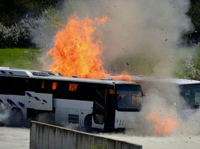 Flames burst from a detonating bus during the reenactment of the Burgas bus bombing near the town of Ihtiman, some 50 kilometers from Sofia, Bulgaria, 26 April 2013. Bulgarian authorities reenacted the 18 July 2012 Burgas bus which killed five Israeli tourists, their Bulgarian bus driver and the terrorist himself. The test bombing was staged on 236 April near Ihtiman, east of the capital Sofia in order to clarify details of the terrorist attack on the airport of the Black Sea city of Burgas. The two buses that were blasted were purchased according to media reports by Europol. Dummies were placed in the vehicles and around in compliance with photos of security cameras and witness reports. Bulgaria said on 05 February that its investigation pointed to the assumption about the involvement of Hezbollah's military wing in the Burgas bus bombing. EPA/VASSIL DONEV