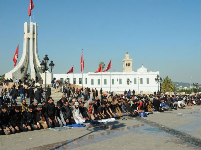 Tunisians pray in the old city of Tunis on December 17, 2013 as they mark the third anniversary of the self-immolation of a young street vendor that sparked the first Arab Spring uprising. Around 1,000 unionists and left-wing opposition activists