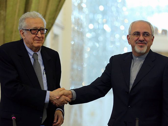 epa03925610 Iranian Foreign Minister Mohammed Javad Zarif (R) shakes hands with UN special envoy to Syria, Lakhdar Brahimi (L) following a joint press conference in Tehran, Iran, 26 October 2013. Brahimi said that Iran's participation in the next Syria peace conference was necessary and the country should therefore be invited. Zarif noted that as soon an invitation was presented, Iran would attend the conference and help with a nonviolent and political solution to the crisis in Syria. Brahimi is visiting Tehran as part of a regional tour to prepare for the Geneva 2 peace conference on Syria, scheduled for 23 November. EPA