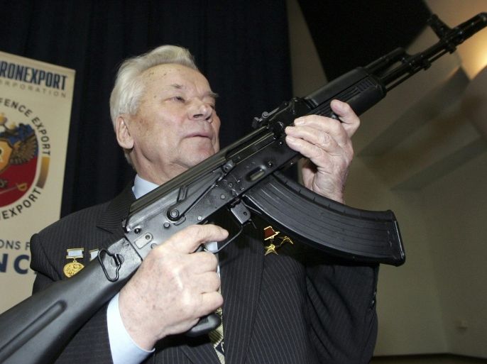 Mikhail Kalashnikov, chief designer of Izhmash Concern, a Russian firearms producer, poses with the latest model of his rifle during a news conference in Moscow in this April 15, 2006 file photo. Kalashnikov, the designer of the assault rifle that has killed more people than any other firearm in the world, died on December 23, 2013, at 94, Russian state news agency Itar-Tass reported. REUTERS/Sergei Karpukhin/Files (RUSSIA - Tags: MILITARY PROFILE)