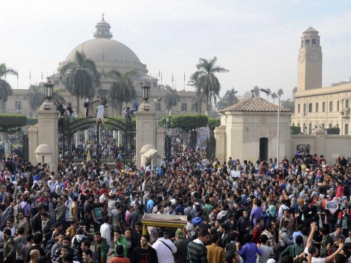 Student protesters gather outside the main gate of Cairo University, Cairo, Egypt Sunday, Dec. 1, 2013. Several hundred students and supporters of the country's ousted Islamist president joined to protest the death of Mohammed Reda, a student who was killed in clashes on Thursday, Nov. 28, 2013, near Cairo University. (AP Photo/Mohammed Asad)