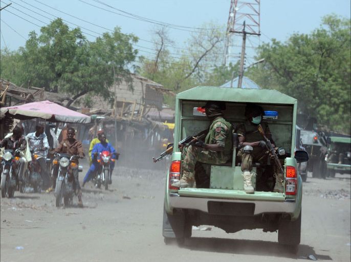 FILES) -- A file photo taken on April 30, 2013 shows joint Military Task Force (JTF) patrolling the streets of the restive northeastern Nigerian town of Maiduguri, Borno State. Attacks by Islamist group Boko Haram in Nigeria's restive northeast