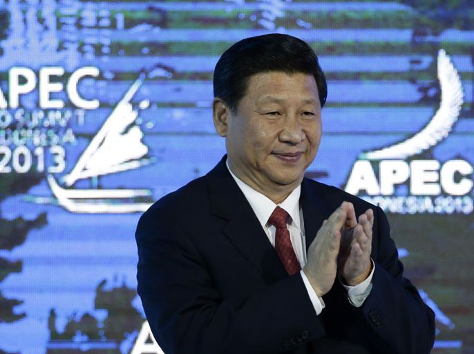 epa03900427 Chinese President Xi Jinping gestures following his keynote address on China's economic outlook at the Asia-Pacific Economic Cooperation (APEC) CEO Summit in Nusa Dua, Bali, Indonesia, 07 October 2013. Indonesia's resort island of Bali is hosting the APEC Summit from 01- 08 October 2013. EPA/DENNIS M. SABANGAN