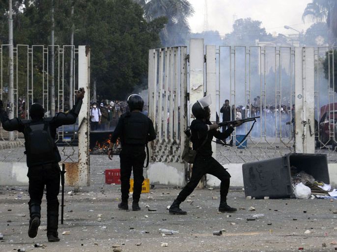 Cairo, -, EGYPT : Egyptian riot police shoot bird-shot to disperse demonstrating students of al-Azhar University who support the Muslim Brotherhood during clashes outside their campus in Cairo on December 9, 2013. Police have shown little tolerance for the Islamists' rallies since Morsi's removal, and a new law allows them to clamp down hard on all but interior ministry-sanctioned demonstrations. AFP PHOTO / TAREK WAJEH