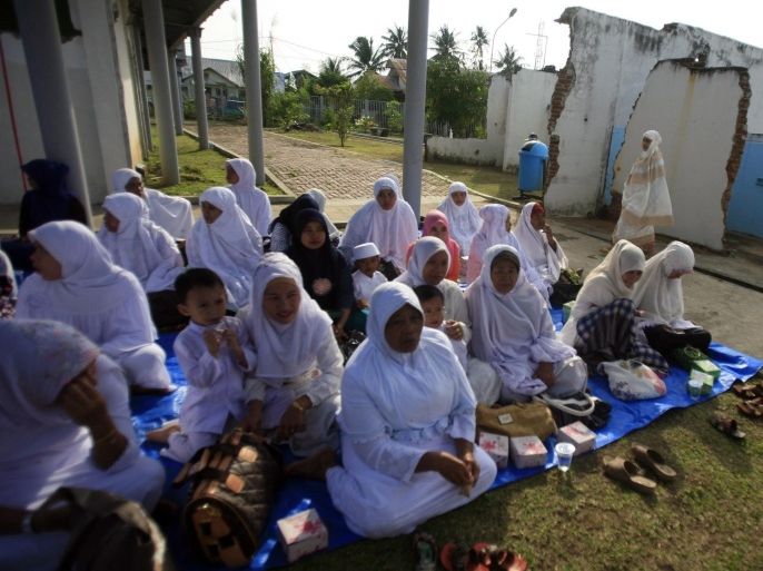 Tsunami survivors pray near the ruins of a house destroyed by a tsunami during the ninth commemoration of the tsunami victims at Banda Aceh, Indonesia, 26 December 2013. Thousands of tsunami survivors performed a mass prayer in remembering their relatives who died during the natural disaster occurred on 26 December 2004. The tsunami claimed more than two hundred thousand lives in Aceh and it also hit many other countries in Indian Ocean.