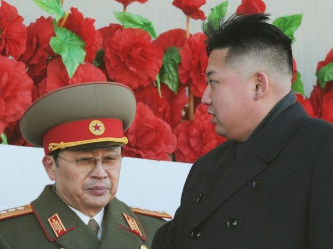North Korean leader Kim Jong-un (R), walks past his uncle North Korean politician Jang Song-thaek, during a military parade to mark the birth anniversary of the late leader, Kim Jong-il in Pyongyang, in this file photo taken by Kyodo February 16, 2012. Jang, North Korean leader Kim Jong Un's uncle, widely believed to be the power behind the throne in the secretive dynastic state, has been dismissed from his post, South Korean media said on December 3, 2013, citing officials at Seoul's top spy agency. Yonhap news agency and YTN cable news channel said Jang Song Thaek, who holds the title of vice chairman of the North's powerful National Defence Commission, had been removed from his post, citing the National Intelligence Service. MANDATORY CREDIT REUTERS/Kyodo/File (NORTH KOREA - Tags: POLITICS OBITUARY) FOR EDITORIAL USE ONLY. NOT FOR SALE FOR MARKETING OR ADVERTISING CAMPAIGNS. THIS IMAGE HAS BEEN SUPPLIED BY A THIRD PARTY. IT IS DISTRIBUTED, EXACTLY AS RECEIVED BY REUTERS, AS A SERVICE TO CLIENTS. MANDATORY CREDIT. JAPAN OUT. NO COMMERCIAL OR EDITORIAL SALES IN JAPAN