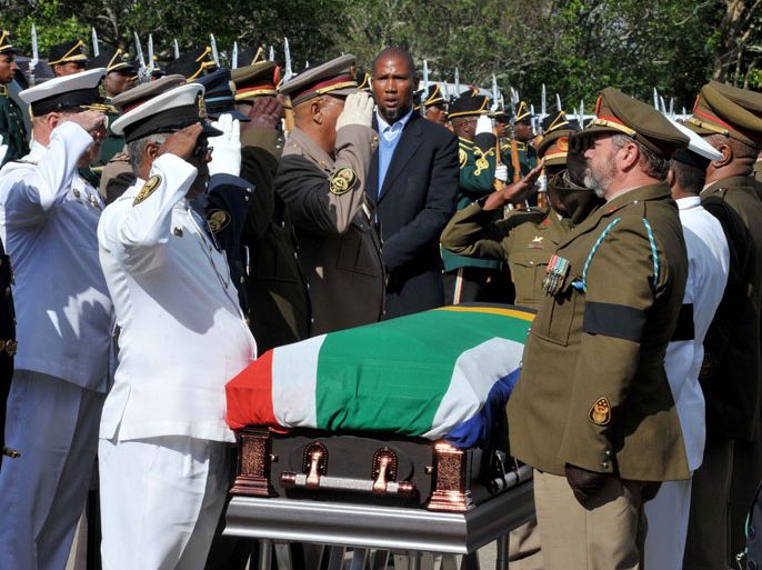 Military salute for the flag-draped coffin of former South African president after it arrived at his home in Qunu in Eastern Cape Province 14 December 2013 ahead of his burial 15 December. EPA/ELMOND JIYANE HANDOUT EDITORIAL USE ONLY/NO SALES