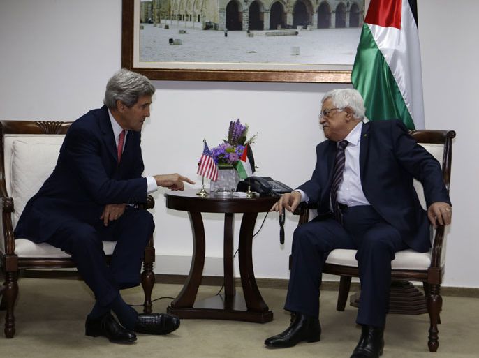 RAMALLAH, WEST BANK, - : US Secretary of State John Kerry (L) meets with Palestinian president Mahmoud Abbas at the Palestinian presidential compound in the West Bank city of Ramallah on December 5, 2013. Kerry started in Jerusalem an official visit that aimed at giving momentum to the direct negotiations, which appear to have made little headway since they began under his patronage in late July. AFP PHOTO POOL MOHAMAD TOROKMAN