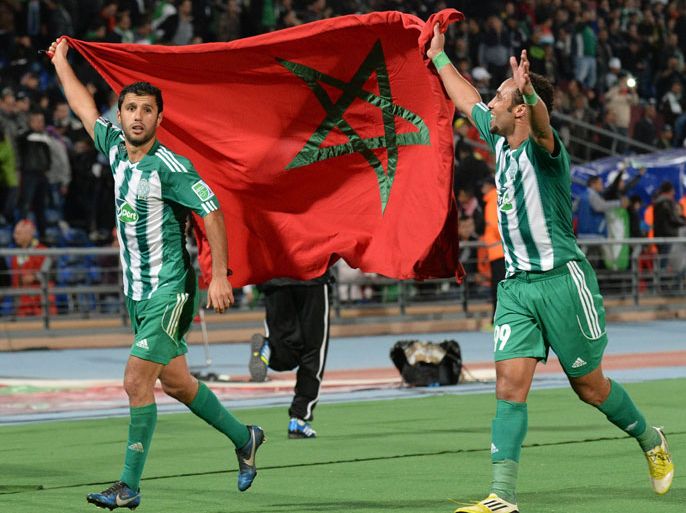 Morocco Raja Casablanca's players hold their national flag as they celebrate after winning the semi-final football match against Brazil's Atletico Mineiro, as part of the 2013 FIFA Club World Cup, in the Moroccan city of Marrakesh, on December 18, 2013. The regional champions from each of the FIFA regions are gathering in the north African country of Morocco to decide which is the best domestic team in the world. AFP PHOTO / FADEL SENNA