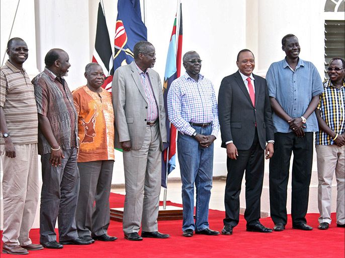 This picture released by the Kenya presidential service shows Kenyan President Uhuru Kenyatta (6th L) posing with the seven detainees released to his custody by South Sudan President after addressing a press conference at State House in Nairobi on January 29,