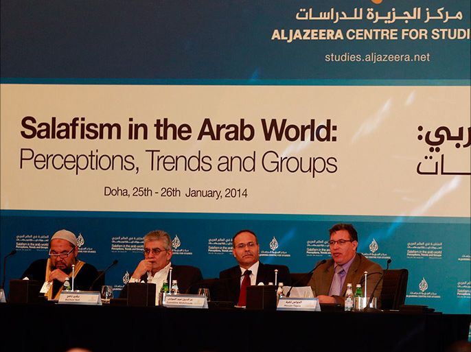 Haoues Taguia (R), a researcher at the Al Jazeera Center of Studies, talks during the "Salafism in the Arab World: Perceptions, Trends and Groups" conference in Doha January 25, 2014. Also seen are (L-2nd R) Salem El Rafei, chairman of the
