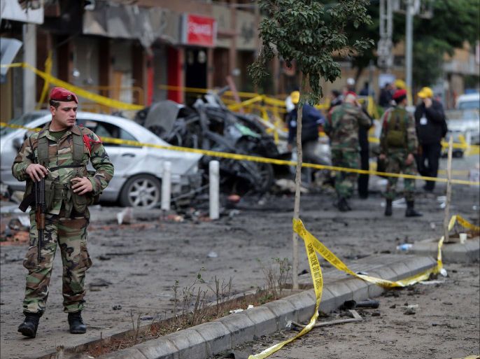 Lebanese forensic experts and Army soldiers inspect the site of a car bomb that targeted Beirut's southern suburb of Haret Hreik on January 03, 2014. A car bomb killed four people in south Beirut the day before, the fourth attack to hit the Hezbollah bastion since the Shiite group announced its intervention in Syria last year, the health minister said. AFP PHOTO/JOSEPH EID