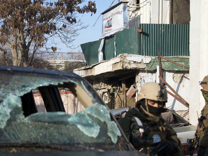 EIS02 - Kabul, -, AFGHANISTAN : Afghan special forces soldiers stand guard next to the damaged entrance of a Lebanese restaurant that was attacked in Kabul, on January 18, 2014. At least 14 people were killed, including foreigners, in a multiple Taliban suicide attack on a popular restaurant in Kabul on January 17, officials said, with two gunmen launching an "indiscriminate" killing spree inside the venue. AFP PHOTO/JOHANNES EISELE