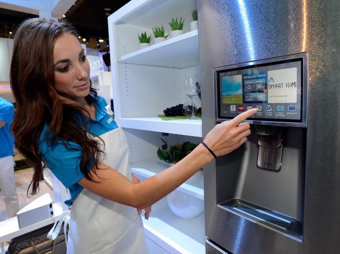 LAS VEGAS, NV - JANUARY 07: Samsung spokesmodel Kai Madden displays the connectivity feature on a Samsung smart refrigerator at the 2014 International CES at the Las Vegas Convention Center on January 7, 2014 in Las Vegas, Nevada. CES, the world's largest annual consumer technology trade show, runs through January 10 and is expected to feature 3,200 exhibitors showing off their latest products and services to about 150,000 attendees.
