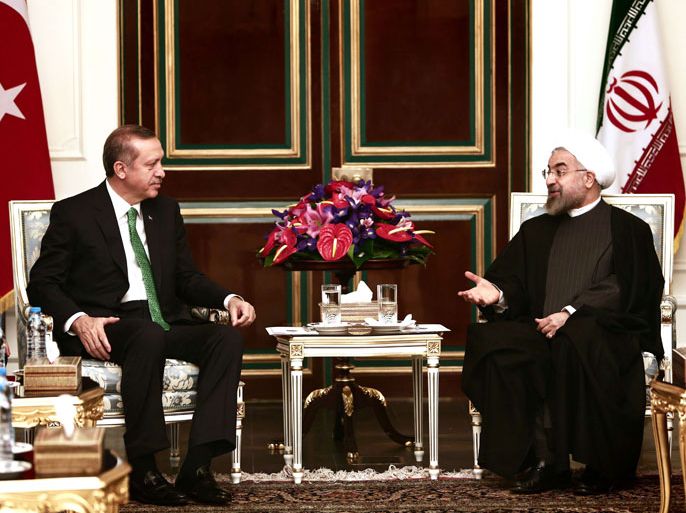 Iranian President Hassan Rouhani (R) meets with Turkish Prime Minister Recep Tayyip Erdogan (L) at Tehran's Saadabad palace on January 29, 2014. Erdogan's visit comes as the two countries are trying to rebuild relations strained by the situation in Syria, with Iran supporting President Bashar al-Assad while Turkey backs the rebels seeking to oust him. AFP PHOTO/BEHROUZ MEHRI