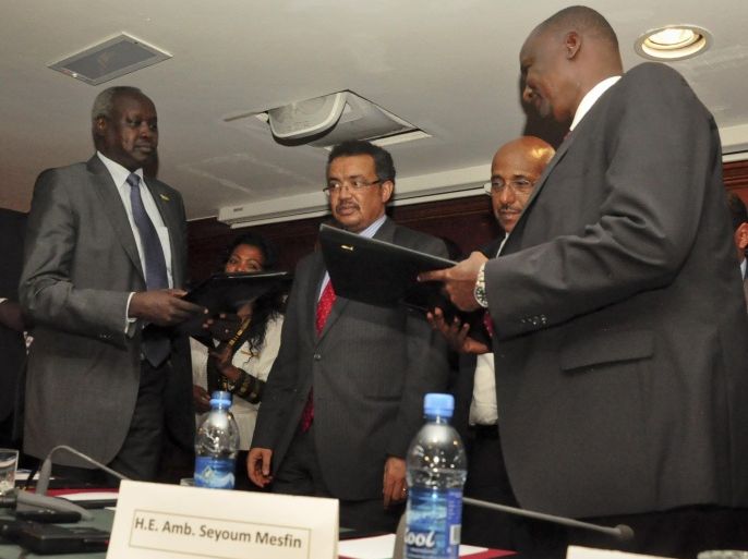 Nhail Deng Nhail, 2nd left, the head of South Sudan's negotiating team, and top negotiator for the rebel's side, Taban Deng Gai, right, a general in South Sudan's army before he defected, sign a cessation of hostilities agreement in front of mediator Ethiopian Foreign Minister Tedros Adhanom, center, in Addis Ababa, Ethiopia Thursday, Jan. 23, 2014. South Sudan's government and rebels fighting against it have signed Thursday a cessation of hostilities agreement in Addis Ababa that should at the least put a pause to five weeks of warfare that has claimed thousands of lives and uprooted a half million people since fighting began Dec. 15 between the government and supporters of former Vice President Riek Machar. (AP Photo/Elias Asmare)