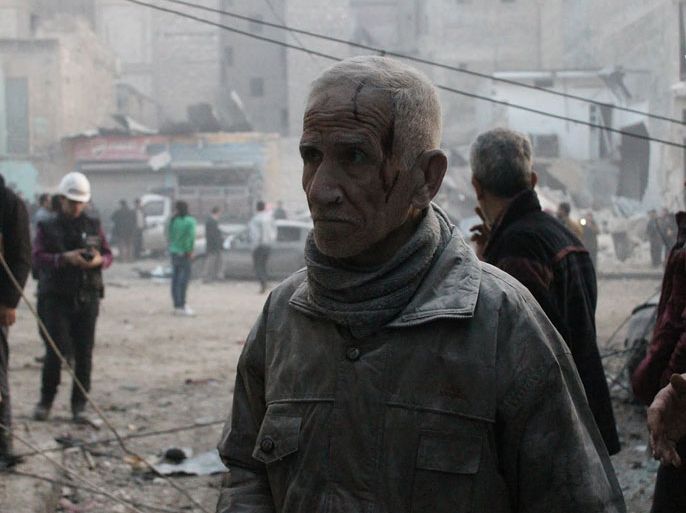 A Syrian man, injured and covered in dust, stands in a street of the northern Syrian city of Aleppo after an alleged air strike by Syrian government forces on January 29, 2014. Syrian government forces dropped barrel bombs on rebel-held districts of Aleppo, killing at least 13 people as they pressed an assault southeast of the northern city, the Syrian Observatory for Human Rights said. AFP PHOTO / MOHAMMED AL-KHATIEB
