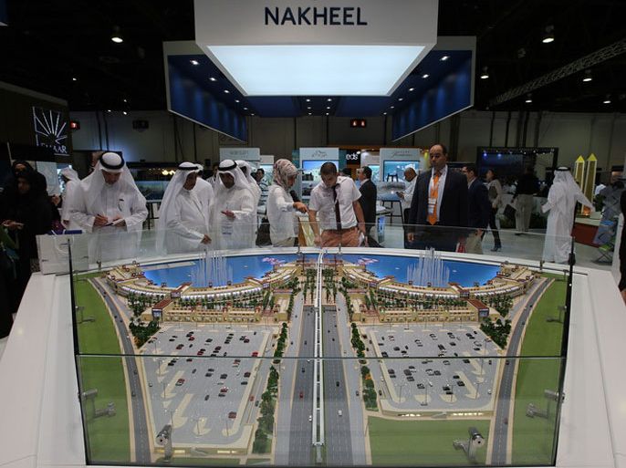epa03902096 Visitors inspect the Dubai developer of Nakheel section at the exhibition of Global Cityscape 2013, at Dubai International Convention and Exhibition Centre, Dubai, United Arab Emirates, 08 October 2013. According to the organizers, the three-day exhibition has attracted 223 regional and international exhibitors, covering six exhibition halls and 25,000 square meters of space. EPA/ALI HAIDER