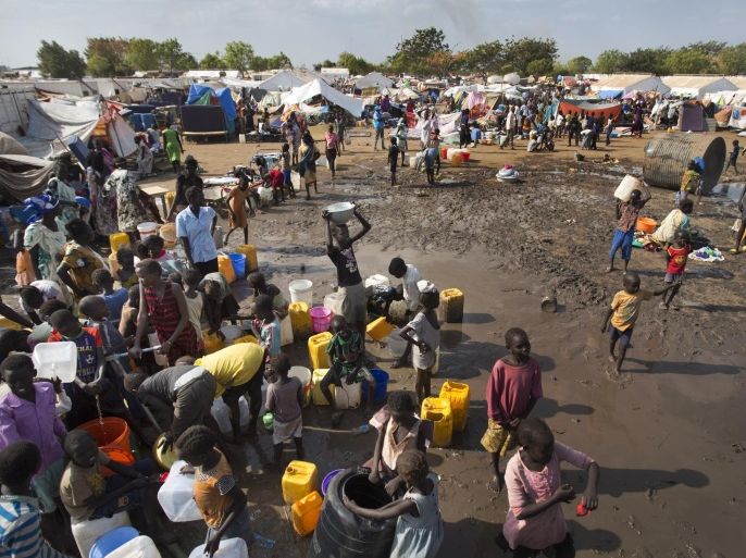 Displaced people gather around a water truck to fill containers at a United Nations compound which has become home to thousands of people displaced by the recent fighting, in the capital Juba, South Sudan Sunday, Dec. 29, 2013. Some 25,000 people live in two hastily arranged camps for the internally displaced in Juba and nearly 40,000 are in camps elsewhere in the country, two weeks after violence broke out in the capital and a spiralling series of ethnically-based attacks coursed through the nation, killing at least 1,000 people. (AP Photo/Ben Curtis)