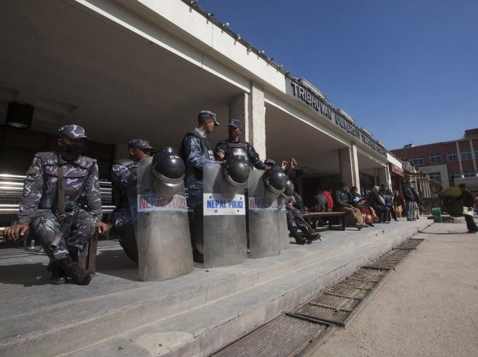 Nepalese policemen guard the Tribhuvan University Teaching Hospital during a strike by doctors in Katmandu, Nepal, Monday, Jan. 20, 2014. Thousands of doctors across Nepal stayed away from work to support a colleague who has been on a hunger strike for days demanding reforms in medical education. Tens of thousands of patients have been deprived of medical services because of the doctors’ strike. Only emergency services are being provided. (AP Photo/Bikram Rai)
