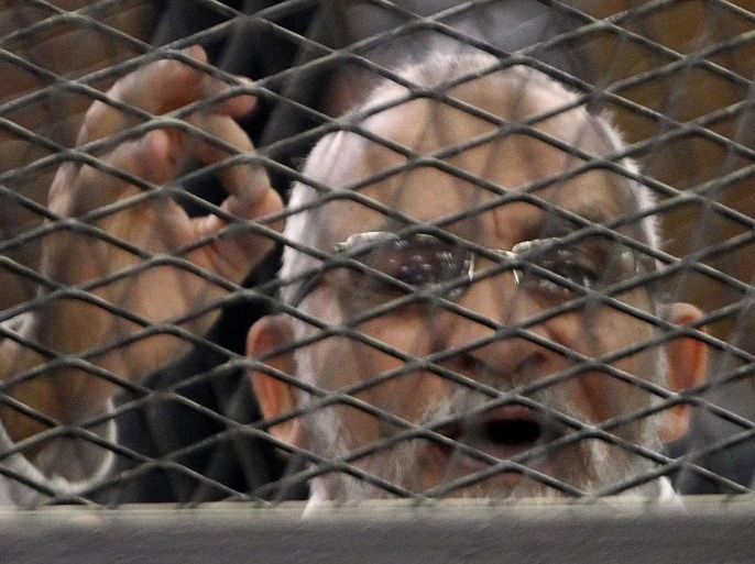 Muslim Brotherhood leader Mohammed Badie shouts slogans from the defendant's cage during his trial with other leaders of the group in a courtroom in Cairo December 11, 2013. Prominent members of the Brotherhood were arrested in a state crackdown on the group following the army overthrow of President Mohamed Mursi and are charged with perpetrating violence during July's clashes. REUTERS/Stringer (EGYPT - Tags: POLITICS CRIME LAW)