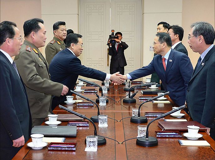 epa04070864 A handout picture made available by the South Korean Ministry of Unification shows South Korean chief delegate Kim Kyou-hyun (2-R) shaking hands with his North Korean counterpart Won Dong-yeon (3-R) before holding talks at the inter-Korean peace village Panmunjom, South Korea, 12 February 2014. Kim is the chief of the presidential office Cheong Wa Dae's National Security Council secretariat. Won is the deputy chief of the North's United Front Department. BEST QUALITY AVAILABLE EPA/SOUTH KOREAN MINISTRY OF UNIFICATION SOUTH KOREA OUT HANDOUT EDITORIAL USE ONLY/NO SALES