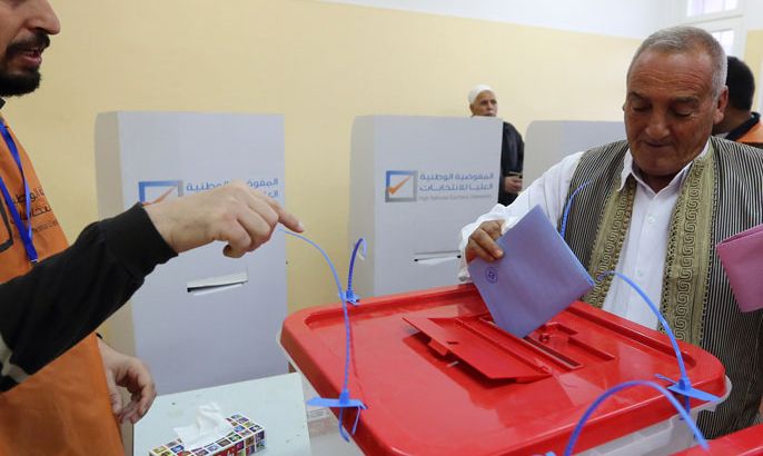 A Libyan man casts his vote to elect a constituent assembly at a polling station in the capital Tripoli on February 20, 2014. Libyans went to the polls today to elect a constitution-drafting panel in the latest milestone in the chaotic political transition from the ousted dictatorship of Moamer Kadhafi. AFP