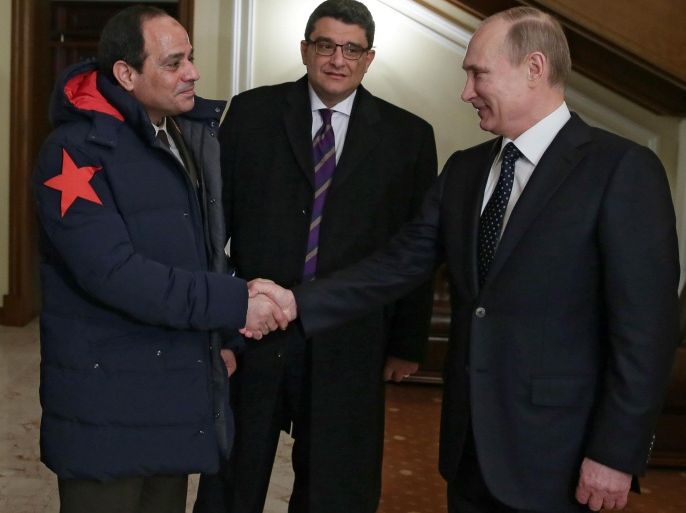 Russian President Vladimir Putin, right, shakes hands with Egypt's military chief Field Marshal Abdel-Fattah el-Sissi, left, in the Novo-Ogaryovo residence outside Moscow on Thursday, Feb. 13, 2014. Russian President Vladimir Putin on Thursday wished Egypt's military chief victory in the nation's presidential vote as Moscow sought to expand its military and other ties with a key U.S. ally in the Middle East. Egyptian Ambassador to Russia Abdelsattar Mohamed Elbadri stands at center.(AP Photo/RIA Novosti, Mikhail Metzel, Presidential Press Service)