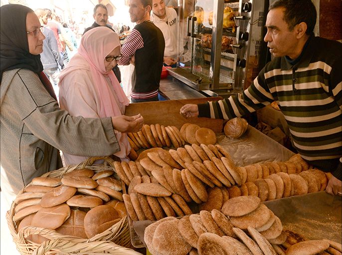 Moroccan women buy bread in Rabat on March 25, 2014, the day before bakers begin a two-day strike in the kingdom which was announced by the Moroccan National Federation of Bakery and Pastry. The bakers are going on strike to protest the government's refusal to allow bread prices to rise. AFP PHOTO/FADEL SENNA