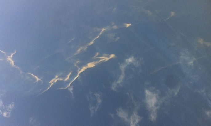 An aerial view of an oil spill is seen from a Vietnamese Air Force aircraft in the search area for a missing Malaysia Airlines plane, 250 km from Vietnam and 190 km from Malaysia, in this handout photo from Thanh Nien Newpaper taken on March 8, 2014. The Malaysia Airlines flight carrying 227 passengers and 12 crew went missing off the Vietnamese coast on Saturday as it flew from Kuala Lumpur to Beijing and was presumed to have crashed. There were no reports of bad weather and no sign why the Boeing 777-200ER, powered by Rolls-Royce Trent engines, would have vanished from radar screens about an hour after take-off. Mandatory Credit REUTERS/Trung Hieu/Thanh Nien Newspaper (VIETNAM - Tags: DISASTER TRANSPORT TPX IMAGES OF THE DAY) ATTENTION EDITORS - NO SALES. NO ARCHIVES. FOR EDITORIAL USE ONLY. NOT FOR SALE FOR MARKETING OR ADVERTISING CAMPAIGNS. THIS IMAGE HAS BEEN SUPPLIED BY A THIRD PARTY. IT IS DISTRIBUTED, EXACTLY AS RECEIVED BY REUTERS, AS A SERVICE TO CLIENTS. MANDATORY CREDIT. VIETNAM OUT. NO COMMERCIAL OR EDITORIAL SALES IN VIETNAM