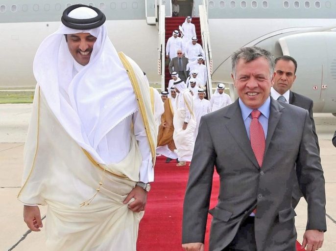 A handout picture made available by the Jordanian Royal Palace shows Jordan King Abdullah II (R) walking with Emir of Qatar Sheikh Tamim bin Hamad Al-Thani (L) upon his arrival at Amman Airport, in Amman, Jordan, 30 March 2014. Media reports state Sheikh Tamim arrived on a one-day official visit to Jordan for talks with King Abdullah II on bilateral ties and issues of mutual interest. EPA/JORDANIAN ROYAL PALACE/HANDOUT