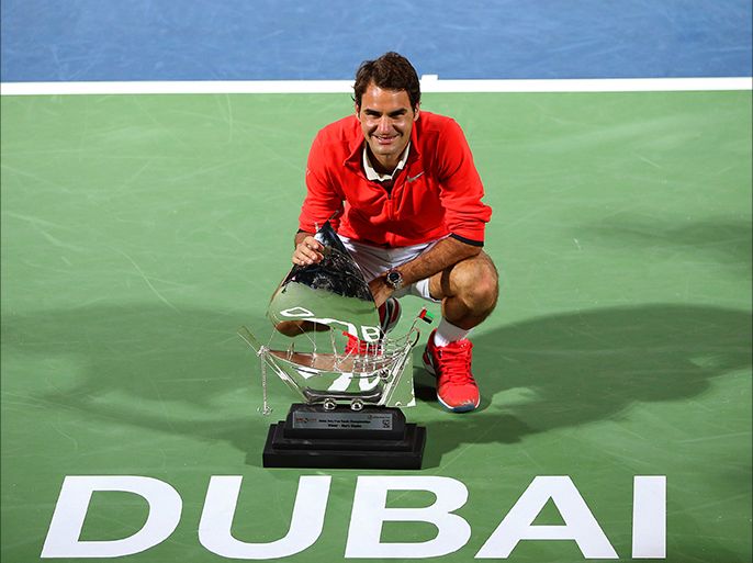 epa04105171 Roger Federer of Switzerland poses with his trophy after beating Tomas Berdych of the Czech Republic in their final match of the Dubai Duty Free Tennis ATP Championships in Dubai, United Arab Emirates, 01 March 2014