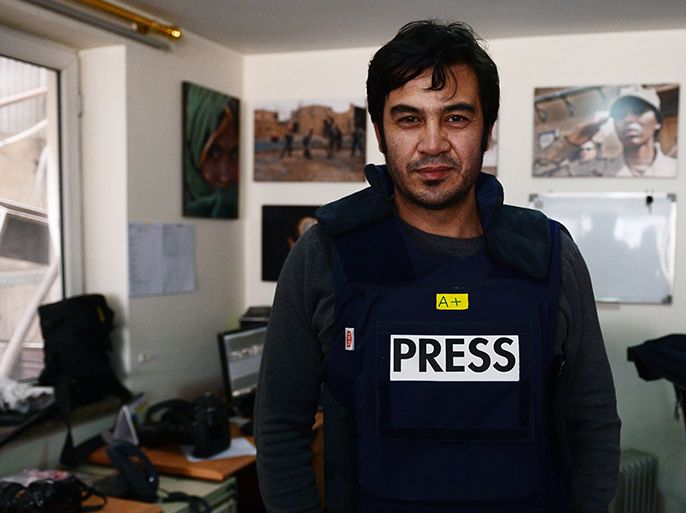 In this picture taken on March 20, 2014, Sardar Ahmad, 40, a Kabul based staff reporter at the Agence France-Presse (AFP) news agency poses for a photo at the AFP office in Kabul hours before he, his wife and two of his three children were gunned down when four teenage gunmen attacked Kabul's Serena hotel. An AFP staff photographer identified the four bodies at a city hospital and said the family's youngest son was undergoing emergency treatment after being badly wounded in the attack. AFP