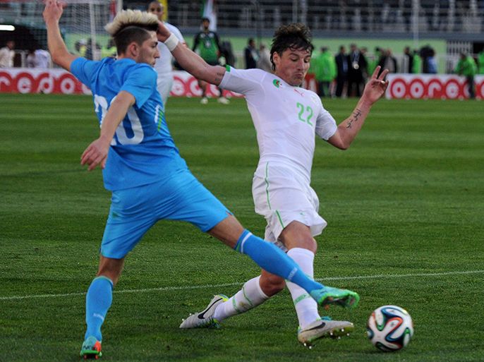 Algeria's Mostefa Sebba Mehdi (R) challenges Slovenia's Kampl Kevin for the ball during their international friendly football match at the Stade Mustapha Tchaker Stadium in Blida, south of the capital Algiers, on March 5, 2014. AFP