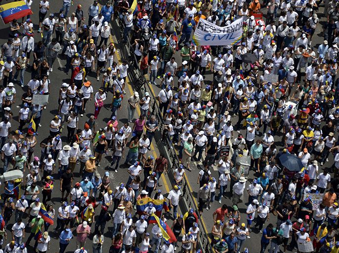 Opposition activists march toward the Cuban embassy to protest against the Cuban interference in Venezuela's internal affairs and against the government of President Nicolas Maduro, in Caracas on March 16, 2014. Venezuela has seen almost daily anti-government demonstrations over violent crime, shortages of essential goods such as toilet paper, and soaring inflation, in the most serious challenge yet for Maduro since he succeeded late socialist-populist Hugo Chavez last year. AFP