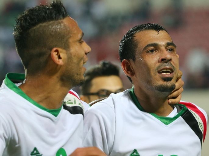 Younes Mahmood (R) of Iraq celebrates with his colleague Ali Adnan Kadhim al-Tameemi after scoring the second goal for his team against China during their match in the Asian Cup Australia 2015 qualification football match, Iraq vs China, in Sharjah, on March 5, 2014. AFP PHOTO/MARWAN NAAMANI