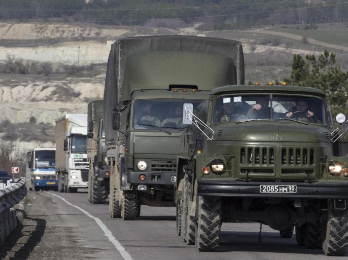 Russian Army trucks drive on the road from Sevastopol to Simferopol in the Crimea region March 1, 2014. Armed men took control of two airports in the Crimea region on Friday in what Ukraine's government described as an invasion and occupation by Russian forces, raising tension between Moscow and the West. REUTERS/Baz Ratner (UKRAINE - Tags: TRANSPORT MILITARY CIVIL UNREST)