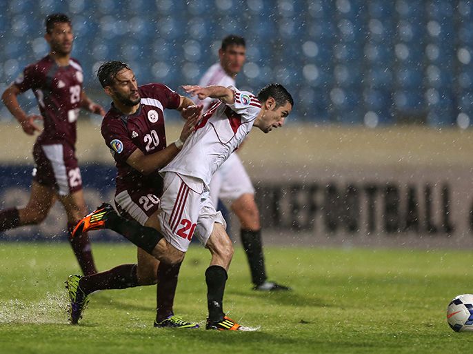 Syrian Al-Jaish Club player Mohammad Ali (R) challenges Lebanese club Nejmeh player Khaled Takaji during their AFC Cup football match in Beirut on March 11, 2014. AFP