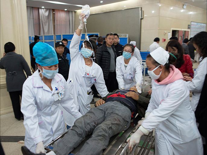 An injured man is pushed at a hospital after a knife attack at Kunming railway station, Yunnan province, March 1, 2014. Witnesses to chilling violence at a Chinese train station placed under heavy security on Sunday recalled moments of fear and chaos after at least 29 people were killed in what authorities called a terrorist attack by Xinjiang militants. Picture taken March 1, 2014. REUTERS/Stringer (CHINA - Tags: CIVIL UNREST CRIME LAW) CHINA OUT. NO COMMERCIAL OR EDITORIAL SALES IN CHINA