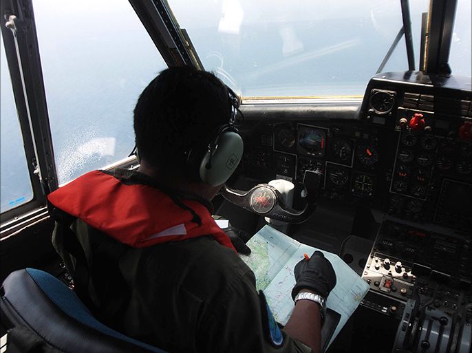 An Indonesian Navy pilot conducts an aerial search for the missing Malaysia Airlines flight MH370 in the waters bordering Indonesia, Malaysia and Thailand on March 10, 2014. Mystery deepened on March 10 over the fate of the Malaysian jet carrying 239 people, as tests on oil slicks scotched suspicions it was aircraft fuel while the search for debris failed to yield any trace of the missing aircraft. AFP PHOTO / ATAR