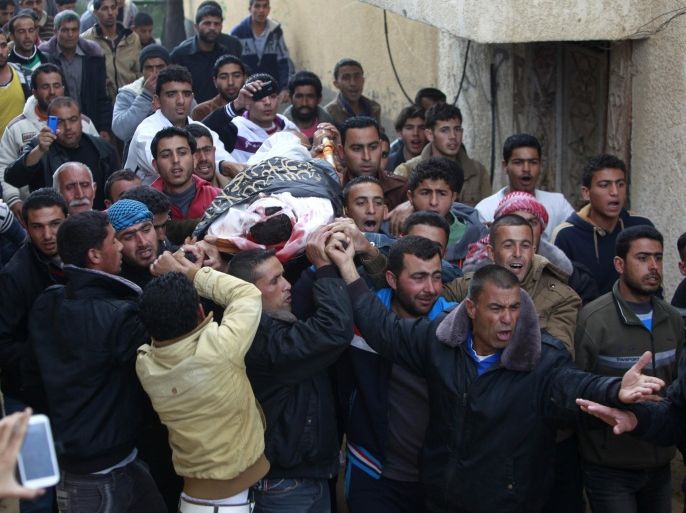 Palestinian mourners carry the body of Islamic Jihad militant Shaher Abu Shanab, who was killed with other two militants in an Israeli airstrike, during his funeral at his family house in Rafah, in the southern Gaza Strip, Tuesday, March 11, 2014. An Israeli airstrike killed three Gaza militants on Tuesday near an area where an unmanned Israeli surveillance aircraft crashed earlier in the day, a Gaza official said. The Israeli military said the Skylark drone experienced a technical malfunction and it was investigating what caused it to go down. (AP Photo/Adel Hana)
