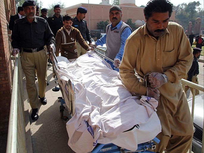 Pakistani paramedics and policemen move the body of a rape victim from a hospital in Multan on March 14, 2014. A Pakistani teenager died on March 14 after setting herself on fire after a court dropped charges against four men accused of raping her, police said. The incident occured in Muzaffargar district of Punjab province, where the horrific gang rape of an illiterate women in 2002 made headlines around the world. AFP PHOTO / SS MIRZA