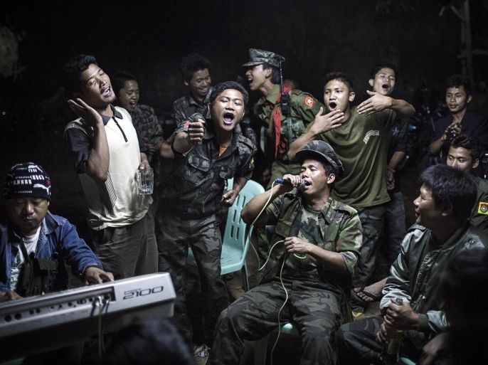 In this photo provided on Friday Feb.14, 2014 by World Press Photo, the 1st prize in the Daily Life Single category of the 2014 World Press Photo Contest by Julius Schrank, Germany, De Volkskrant, shows Kachin Independence Army fighters drinking and celebrating at a funeral of one of their commanders who died the day before, Burma, March 15, 2013. (AP Photo/Julius Schrank, De Volkskrant) NO SALES NO ARCHIVE