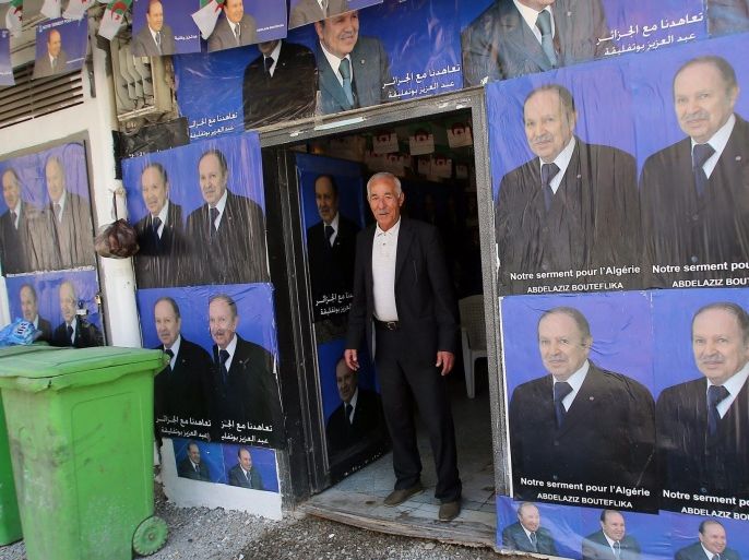 An Algerian man stands next to electoral campaign posters for Algerian President Abdelaziz Bouteflika in Algiers, Algeria, 16 March 2014. The Algerian Constitutional Council announced on 13 March 2014 a list of six candidates who will run in the presidential elections scheduled for 17 April.